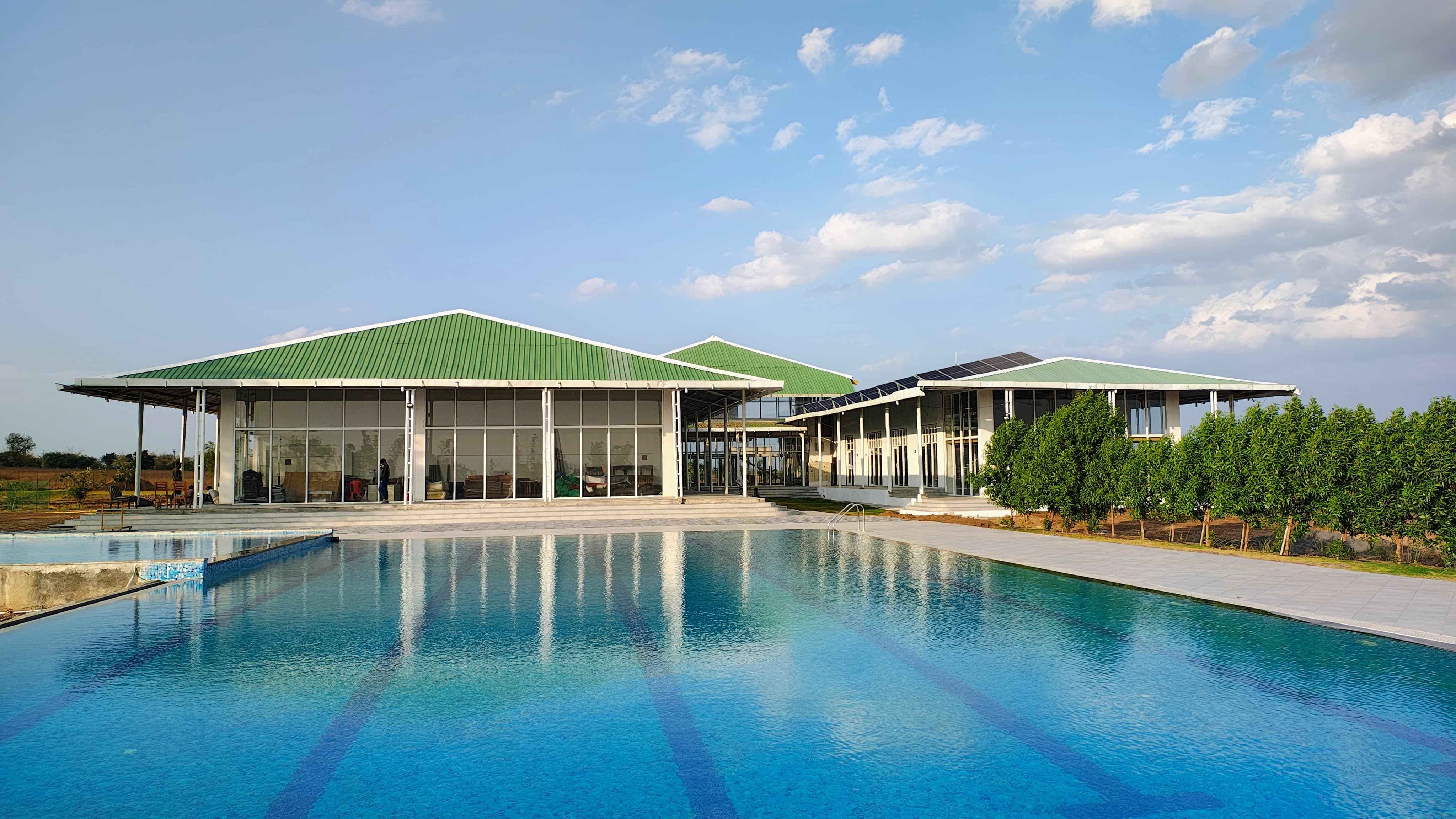 Ambanagri Sports City clubhouse and pool