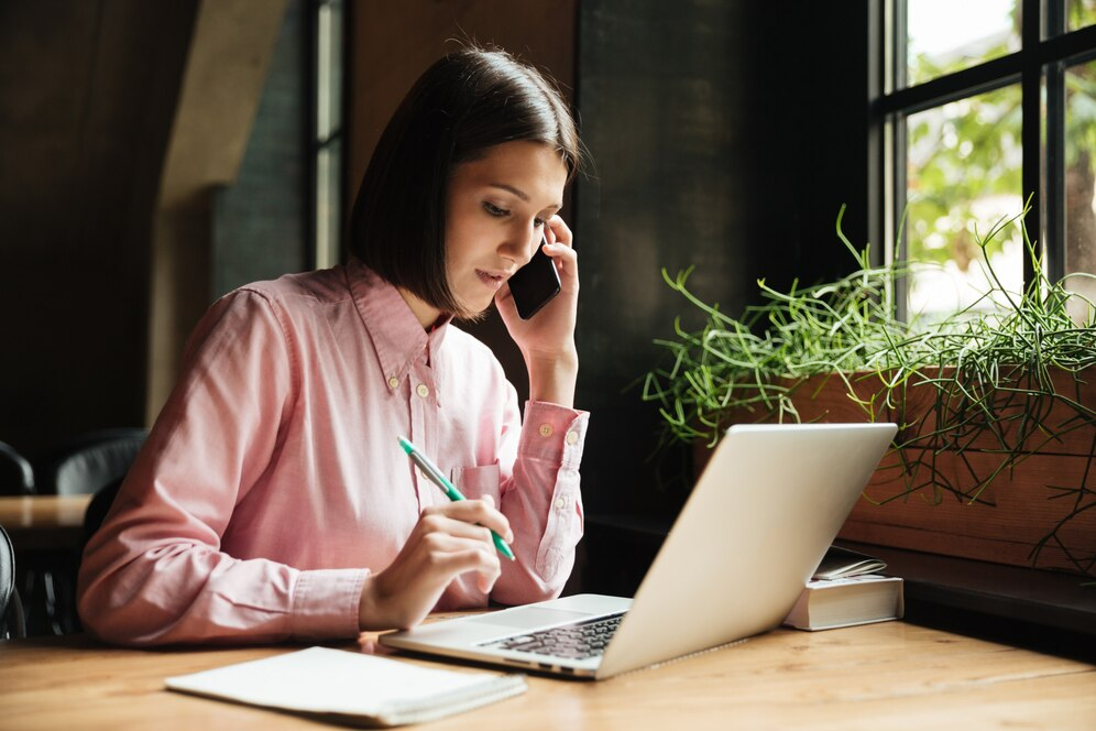 Woman on the phone with a laptop